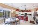 Eat-in kitchen featuring stainless steel appliances, breakfast bar, and dining nook with backyard views at 7126 Southgate Ct, Sarasota, FL 34243