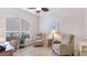Bright living room featuring tiled flooring, two recliner chairs, and a large window at 7126 Southgate Ct, Sarasota, FL 34243