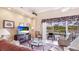 Bright living room with large sliding glass doors leading to a screened-in patio and a pool at 7126 Southgate Ct, Sarasota, FL 34243