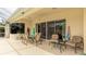 Covered patio with comfortable seating, an outdoor dining area, and access to the screened-in pool at 7126 Southgate Ct, Sarasota, FL 34243