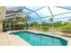Enclosed pool featuring outdoor seating and an umbrella overlooking the backyard at 7126 Southgate Ct, Sarasota, FL 34243