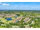 Scenic community view with lush landscapes, a tranquil lake, and residential properties at 7160 Cedar Hollow Cir, Bradenton, FL 34203