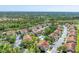 Aerial shot capturing residential properties, a refreshing pool, and lush landscaping at 7160 Cedar Hollow Cir, Bradenton, FL 34203