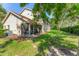 Scenic backyard with a screened-in patio, lush green grass, and an AC unit at 7160 Cedar Hollow Cir, Bradenton, FL 34203