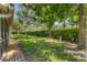 Lush backyard featuring grass, well-manicured bushes, and a tranquil environment at 7160 Cedar Hollow Cir, Bradenton, FL 34203