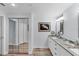 Contemporary bathroom boasts double sinks, granite countertops, and mirrored closet doors at 7160 Cedar Hollow Cir, Bradenton, FL 34203