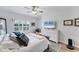 Bedroom with a ceiling fan, white dresser and large window with view to exterior at 7160 Cedar Hollow Cir, Bradenton, FL 34203
