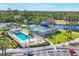 Aerial view of the clubhouse with a pool and tennis courts nearby, showcasing community amenities at 7160 Cedar Hollow Cir, Bradenton, FL 34203