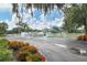 Community entrance featuring a gated entrance surrounded by lush landscaping and flowers at 7160 Cedar Hollow Cir, Bradenton, FL 34203