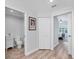 Hallway view showing access to the bathroom, bedroom, and closet space with laminate flooring at 7160 Cedar Hollow Cir, Bradenton, FL 34203