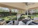 Screened in Lanai featuring outdoor furniture, ceiling fan, and view of landscaped yard at 7160 Cedar Hollow Cir, Bradenton, FL 34203