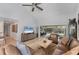 Bright living room featuring high ceilings, modern ceiling fan, and screened outdoor space at 7160 Cedar Hollow Cir, Bradenton, FL 34203