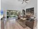 Bright living room featuring high ceilings, modern ceiling fan, and screened outdoor space at 7160 Cedar Hollow Cir, Bradenton, FL 34203