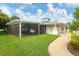 An outdoor patio featuring picnic tables in a covered and screened area at 7160 Cedar Hollow Cir, Bradenton, FL 34203