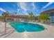 Community pool with lounge chairs and a covered cabana, surrounded by lush landscaping, perfect for relaxation at 7160 Cedar Hollow Cir, Bradenton, FL 34203