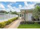 A pathway to the pool area with lush landscaping and a security fence at 7160 Cedar Hollow Cir, Bradenton, FL 34203
