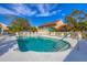 Relaxing community pool surrounded by white fencing and greenery, providing a serene and inviting outdoor space at 7160 Cedar Hollow Cir, Bradenton, FL 34203