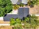 An aerial view of the home's roof, backyard patio area with furniture, and surrounding mature trees at 777 51St N Ave, St Petersburg, FL 33703