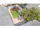 Aerial shot of private patio with dining table, synthetic grass, mature trees, and fully fenced backyard at 777 51St N Ave, St Petersburg, FL 33703