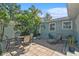 Outdoor patio featuring a dining table, grill, and seating surrounded by tropical landscaping at 777 51St N Ave, St Petersburg, FL 33703