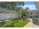 Private backyard oasis with an outdoor dining area, lush greenery, and a well-manicured artificial lawn at 777 51St N Ave, St Petersburg, FL 33703