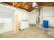 Spacious basement laundry room with washer, dryer, utility sink, and storage shelves at 777 51St N Ave, St Petersburg, FL 33703