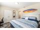 Comfortable bedroom with stylish decor, wood floors, double door closet, and ensuite bathroom at 777 51St N Ave, St Petersburg, FL 33703