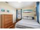 Comfortable bedroom with stylish decor, wood floors, and a chest of drawers at 777 51St N Ave, St Petersburg, FL 33703