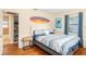 Comfortable bedroom with stylish decor, wood floors, and ensuite bathroom and closet at 777 51St N Ave, St Petersburg, FL 33703