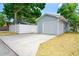 Detached garage with a new concrete driveway, a secure fence, and mature trees in a lovely neighborhood at 777 51St N Ave, St Petersburg, FL 33703