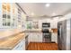 Bright kitchen with white cabinets, granite countertops, and stainless steel appliances at 777 51St N Ave, St Petersburg, FL 33703