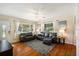 Bright living room featuring hardwood floors, dark leather sofas, and a front door at 777 51St N Ave, St Petersburg, FL 33703