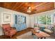Cozy living room featuring a striking blue china cabinet, comfortable seating, and hardwood floors at 777 51St N Ave, St Petersburg, FL 33703