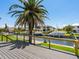 Scenic view from a wooden deck overlooking a canal with boat docks and lush palm trees at 7779 Holiday N Dr, Sarasota, FL 34231