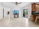 Spacious living room with tile floors and sliding glass doors to the pool at 7779 Holiday N Dr, Sarasota, FL 34231