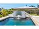 Luxurious pool featuring a custom tiled fountain and crystal-clear, refreshing water at 7779 Holiday N Dr, Sarasota, FL 34231