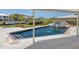 Beautiful pool area with a sleek water feature and a clear blue swimming pool at 7779 Holiday N Dr, Sarasota, FL 34231