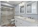 Modern bathroom features dual sinks, new tile, and glass shower door at 800 S Blvd Of The Presidents # 5, Sarasota, FL 34236