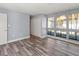 Bright bedroom featuring light walls, vinyl flooring, and large windows at 800 S Blvd Of The Presidents # 5, Sarasota, FL 34236