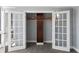 View of walk-in closet with open french doors and stained wood details at 800 S Blvd Of The Presidents # 5, Sarasota, FL 34236