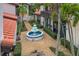 View of community courtyard featuring a three-tier fountain and lush landscaping at 800 S Blvd Of The Presidents # 5, Sarasota, FL 34236