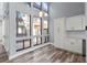 Charming dining area featuring light gray walls, hardwood floors, and large windows with courtyard views at 800 S Blvd Of The Presidents # 5, Sarasota, FL 34236