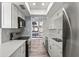 Bright kitchen with stainless steel appliances, white cabinets, and natural light at 800 S Blvd Of The Presidents # 5, Sarasota, FL 34236