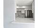 Modern kitchen featuring white cabinets, stone countertops, stainless steel appliances and a serving bar at 800 S Blvd Of The Presidents # 5, Sarasota, FL 34236