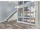 Open concept living area with wood look floors, staircase, white trim, and lots of light at 800 S Blvd Of The Presidents # 5, Sarasota, FL 34236