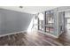 Bright living room with hardwood floors and expansive windows at 800 S Blvd Of The Presidents # 5, Sarasota, FL 34236