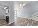 Open concept living room with stairs, lots of light, view to the kitchen and hardwood floors at 800 S Blvd Of The Presidents # 5, Sarasota, FL 34236