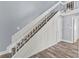 Staircase with carpeted steps, white railings, and a modern chandelier at 800 S Blvd Of The Presidents # 5, Sarasota, FL 34236