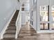 View of a staircase with carpeted steps and white railing, leading to the upper level at 800 S Blvd Of The Presidents # 5, Sarasota, FL 34236