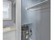 Storage area near bath featuring a water heater and cabinet at 800 S Blvd Of The Presidents # 5, Sarasota, FL 34236
